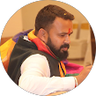 Brown man wearing colorful clothes and having some hindu religious markings.